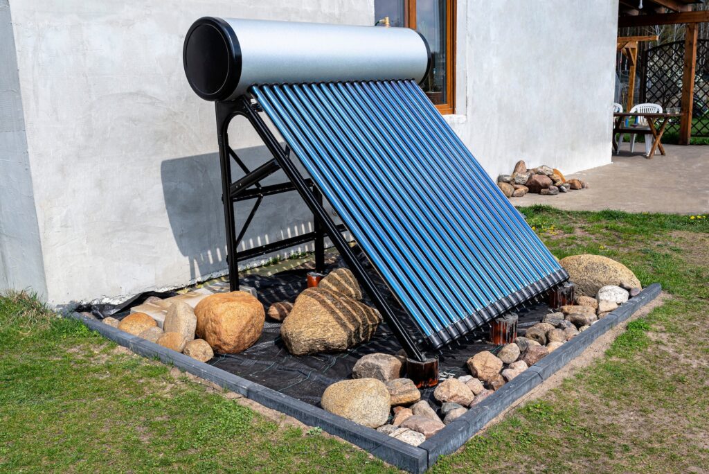 A modern solar pressure collector to heat domestic hot water, standing in front of the house
