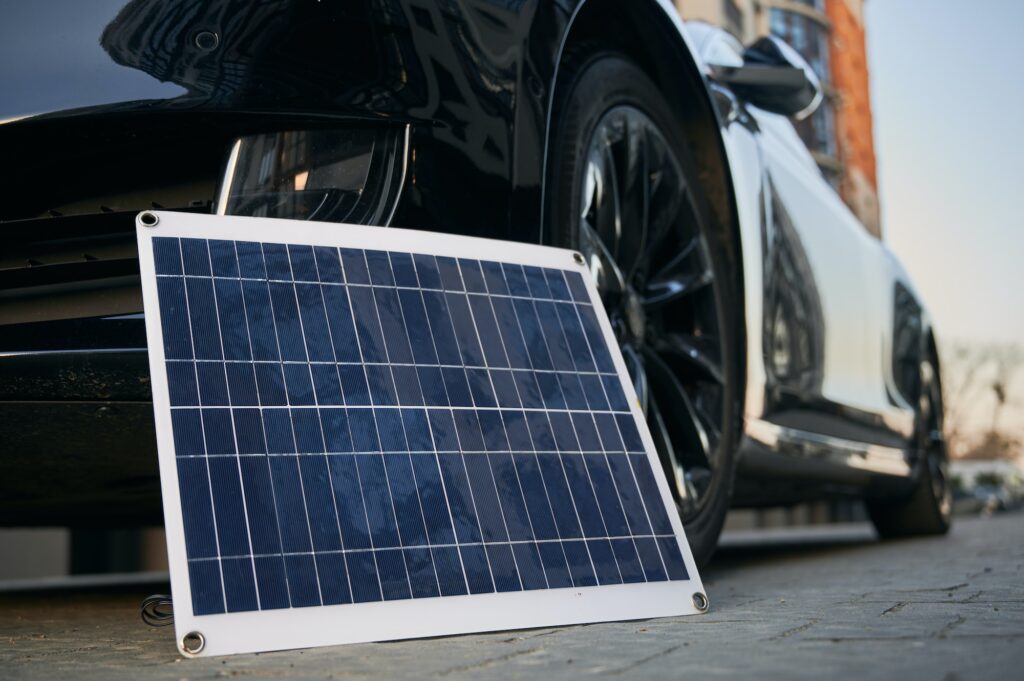 Solar panel and electric car on the street.